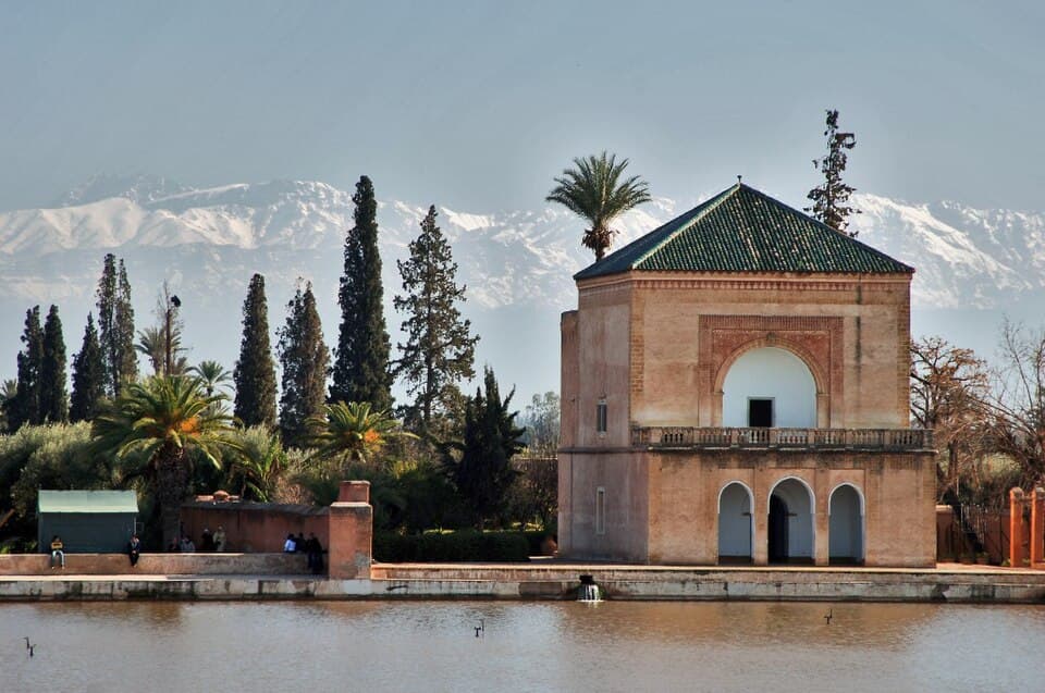 The Menara Gardens pavilion and reflecting pool in Marrakech with the Atlas Mountains behind