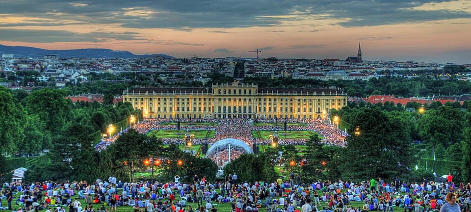 Schönbrunn Palace and gardens during an outdoor concert in Vienna at dusk